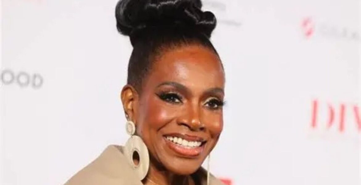 Close-up of Sheryl Lee Ralph smiling at the DIVAs Simply Singing! health awareness event in Los Angeles. She is styled with a sleek high bun and statement earrings, representing her decades of advocacy for HIV/AIDS prevention.