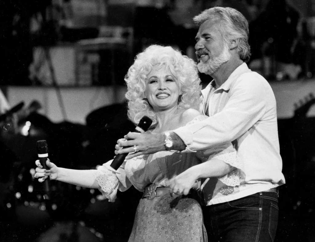 Dolly Parton, left, and Kenny Rogers rehearse a song for their appearance on the TV show “Live... And in Person” in Los Angeles on Sept. 27, 1983