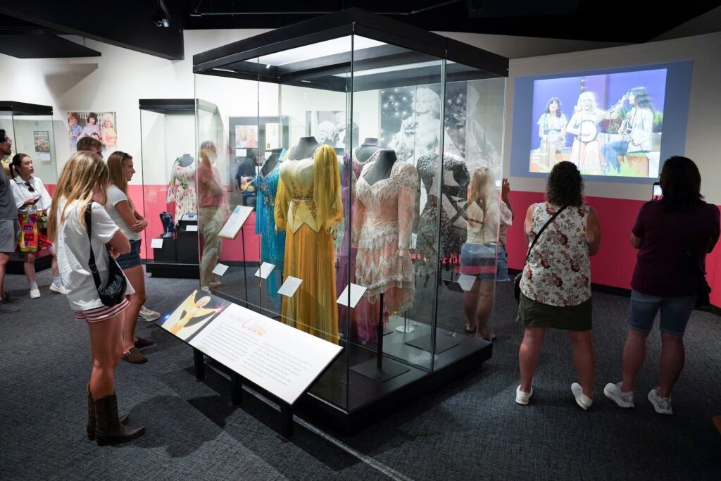 People attend the "Dolly Parton- Journey of a Seeker" exhibition at the Country Music Hall of Fame after it was announced that country music icon Dolly Parton died aged 80, in Nashville, Tennessee, U.S., August 25, 2026. REUTERS