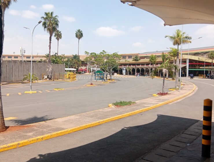 Palm-lined access road and terminal buildings at Jomo Kenyatta International Airport in Nairobi.